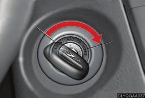 Depress the brake pedal. Turn the ignition key to the START position.