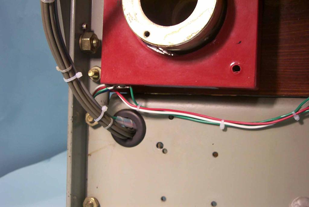 Route the Sensor Harness to the left side of the Breaker, when viewed from the back of the Breaker, then through the existing hole with rubber grommet towards the front of the Breaker.
