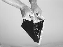Remove the resin bag and place a thumb on each side of the bag next to the barrier strip that keeps the resin from the