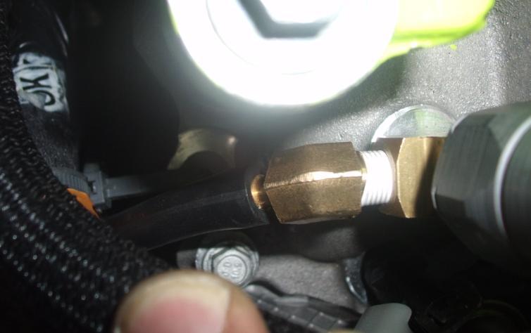 13.a. Install the boost gauge fitting into the port facing the left rear of the vehicle.