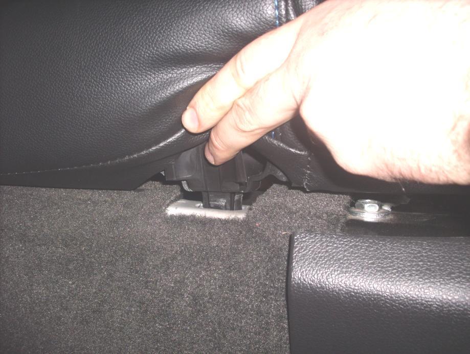 Locate the rear seat-bottom removal tab illustrated below (there are two (2) tabs, one