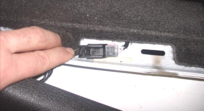 Once the trim panel is loose, disconnect the electrical connector, if