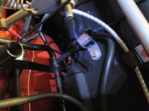 Continue routing the sensor wiring to the top of the firewall and across to the battery carrier using the existing engine bay wiring harness brackets.