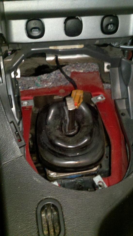 Installation: 1. The first step before getting underneath the car is to remove the shifter: Remove shift knob. Pop off shifter bezel and unplug cigarette lighter plug.