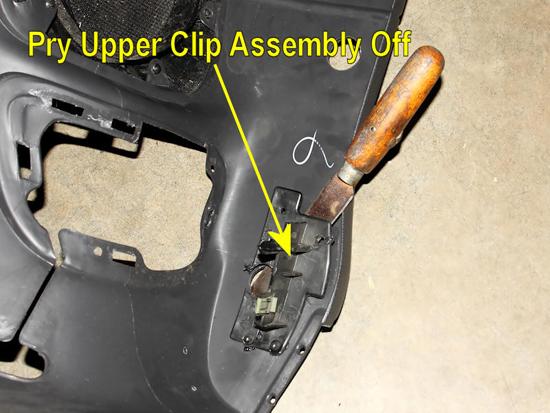 20. Use a putty knife, or similar tool, to pop loose the upper mounting clip assemblies from the inside of the interior panels.