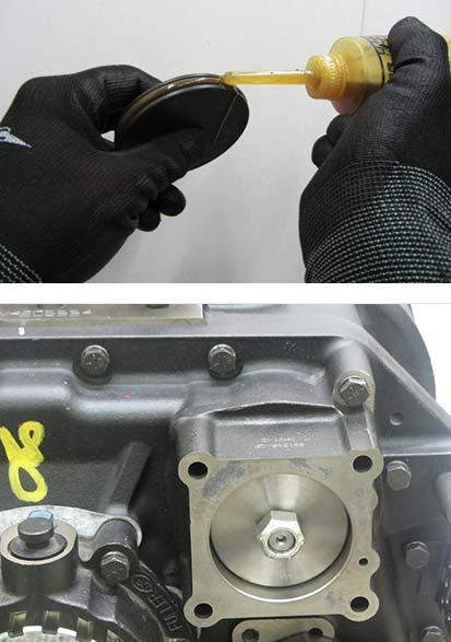 Apply lube to the o-ring on the Range Shift Fork Shaft and Range Cylinder O-ring, install the