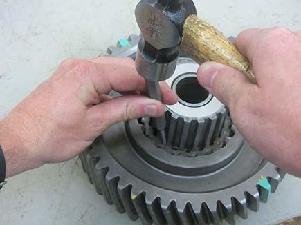 Using a punch and hammer, drive the two coupler pins from the front of the coupler.