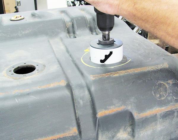 1. Determine the best area on the fuel tank surface to drill the 3.25 diameter hole saw by: a. Identifying where the chassis frame rails contact the fuel tank b.