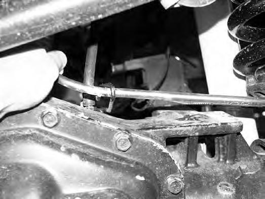 FIGURE 6 FIGURE 7 12. Lower the axle until the spring is free and remove the spring from the vehicle.