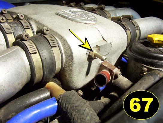 On manual transmission cars, we will be removing the bolt from the front of the intake plenum and installing our fitting, (see photo 66) in it s place and putting a vacuum line in there.