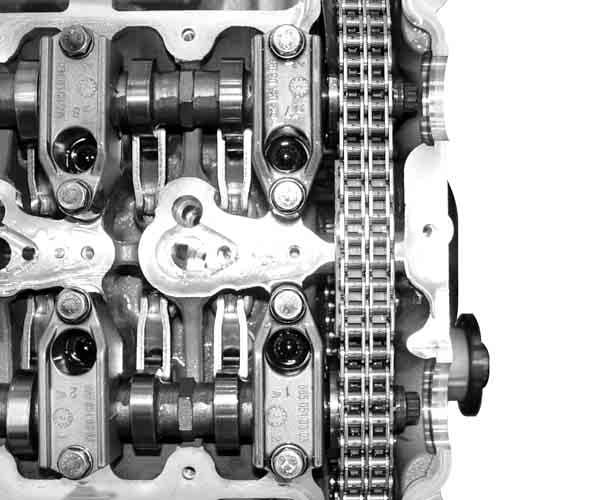 Make sure that the timing chain is securely seated on the guide rail. 5.