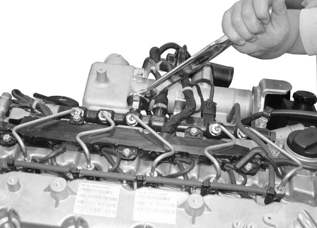 Remove the injector fuel line and connector, and glow plug connector