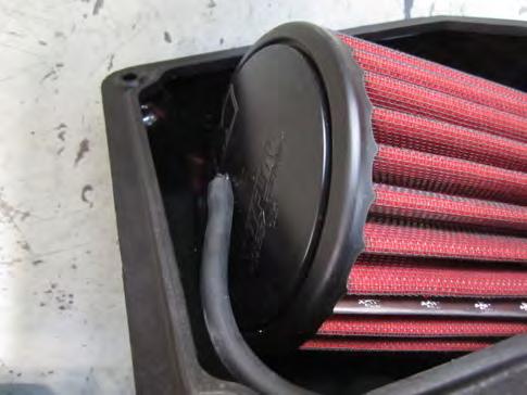 Fully seat the filter onto the intake tube and tighten the hose clamp.