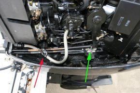 6 Remove the engine cowling to gain access to the shift cable. Unclip the cable barrel retainer (red arrow).