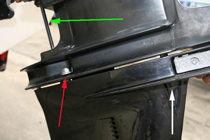 The water tube (red arrow) will need to line up with the water pump guide tube on the gearcase.