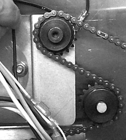 Note: Ensure the drive motor is mounted as far forward as possible, which ensures adequate slack in the chain. With small drive sprockets still loose, return power to the unit and run with side off.