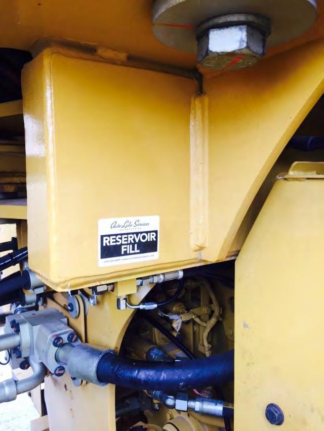 The remote fill block is welded underneath the cab on the left frame member.