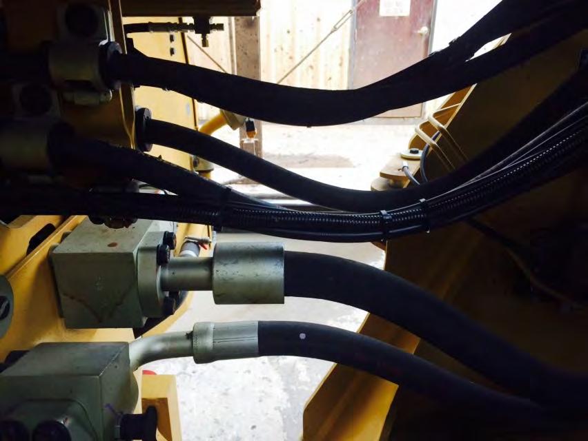 Detail of the lube lines and proximity switch wire passing through the center section.