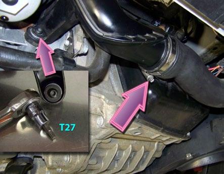 With the car still raised, disconnect the intercooler hose from the bottom of the duct (right arrow).