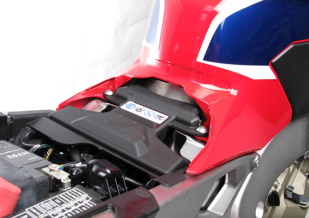 Unscrew marked bolts located on the right and left side, under the back side of driver s seat and remove the seat off the motorcycle (F 01).