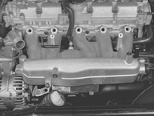 variable valve timing solenoid - Lift up and place the ignition coils and wiring to one side.