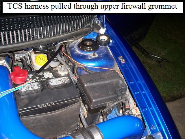 Slowly pull the coat hanger (or antenna) back through the firewall grommet by pulling on the coat hanger (or antenna) from under the hood.