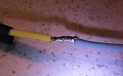 Place one wire through the heat shrink tubing and twist the stranded copper wire together so