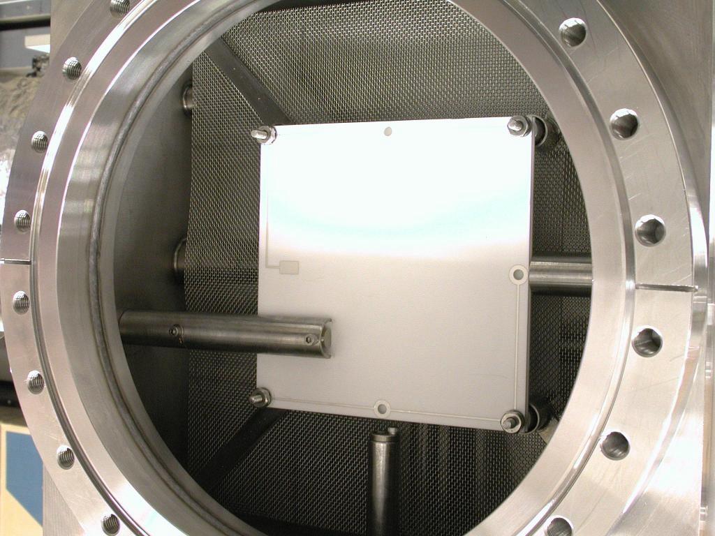 The ion chambers are mounted at their four corners on threaded rods that thread into the beam box and are spaced from one another by stainless washers.