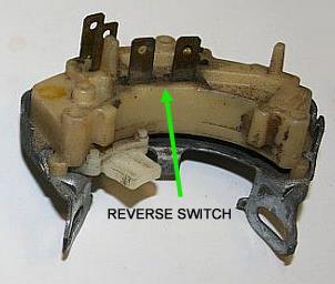 Locate the reverse switch at the base of the steering column. Plug the reverse switch connector onto the 2 pins of the reverse switch.