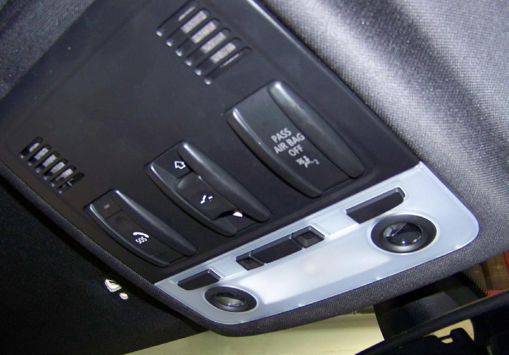 The metal clips snap against the edge of the headliner to hold the console in place.