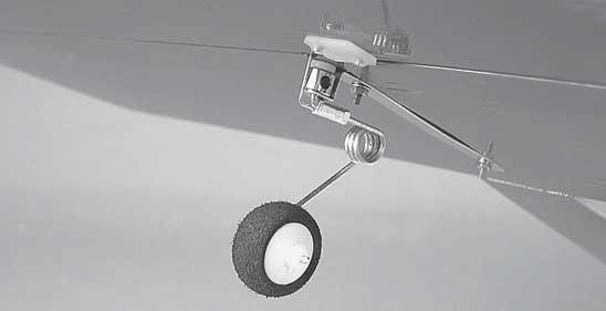 Thread the steering wire between the horizontal stabilizer and the elevator as shown and insert the tail wheel assembly through the tail wheel bracket.