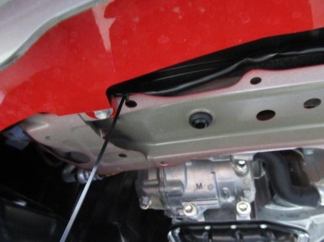 On the driver side, secure excess wire harness with a wire tie and wire tie to