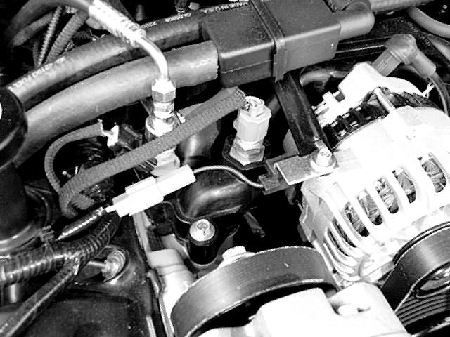 12. IGNITION RELOCATION *A. Separate the passenger side ignition coil from the factory bracket previously removed from the front engine cover. *B.