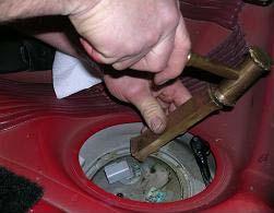 STEP 11: Using a fuel tank lock ring wrench or a brass punch, remove the fuel pump