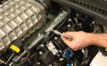Attach the eye terminal to the alternator using a 13mm wrench. Replace the cover on the terminal.