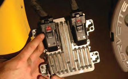 Replace the computer connectors in their original positions, making sure to lock them in place by pushing the grey levers towards the harness.