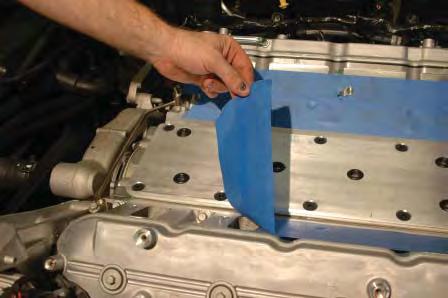 Carefully, set the supercharger assembly on the engine, line up the bolt holes with the holes in the