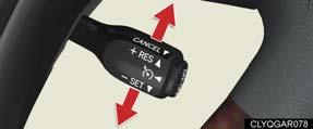 To temporarily cancel the cruise control, pull the lever toward you. To resume the cruise control, push the lever up.