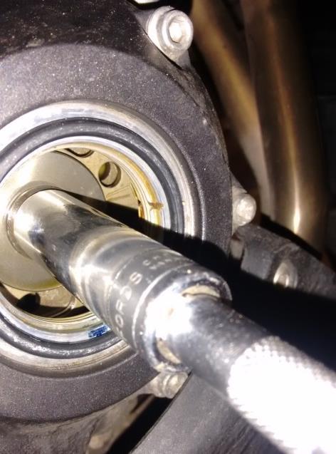 Using a 14mm socket on the crankshaft end nut, rotate the engine until the T mark lines up with the
