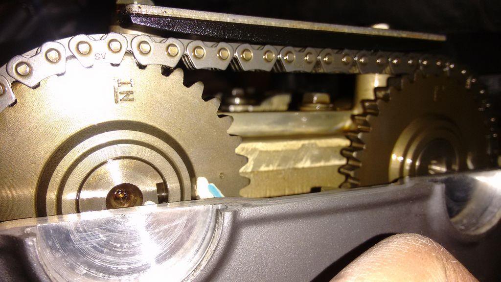 Turn the crank bolt 1/2 a turn clockwise, so that the marks on the camshaft sprockets look like this: Repeat the clearance checking and shim