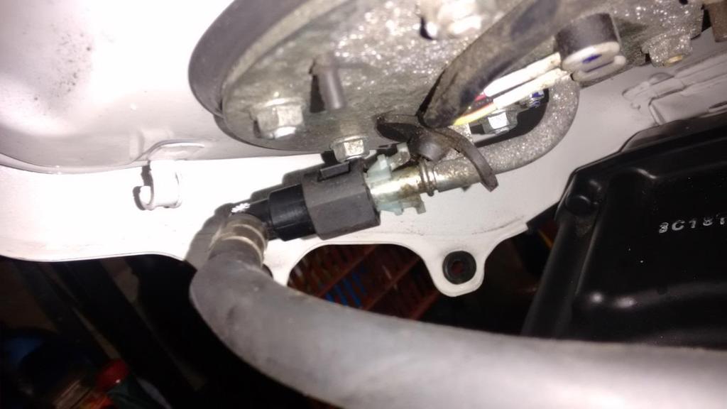 (pinch to release) and the fuel pipe from the pump (pinch white connector clip to release).