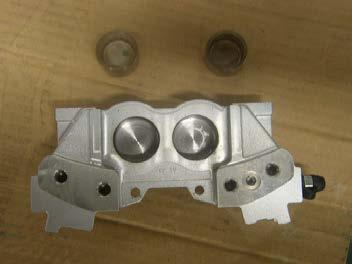 Clean all of the brake caliper components using