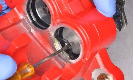 Remove the parking brake piston. Each piston bore has two seals.