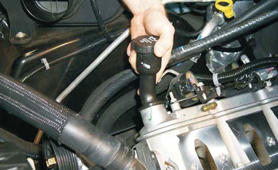 81. Remove the long oil-fi ller neck from the valve cover by rotating it 180 degrees