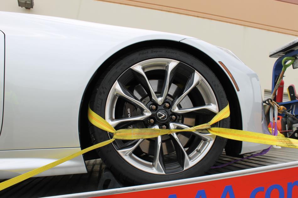 Clearance around the wheel is limited and careful routing of straps is needed to avoid contacting brake lines and wheel speed sensor wires, especially behind the front wheels.