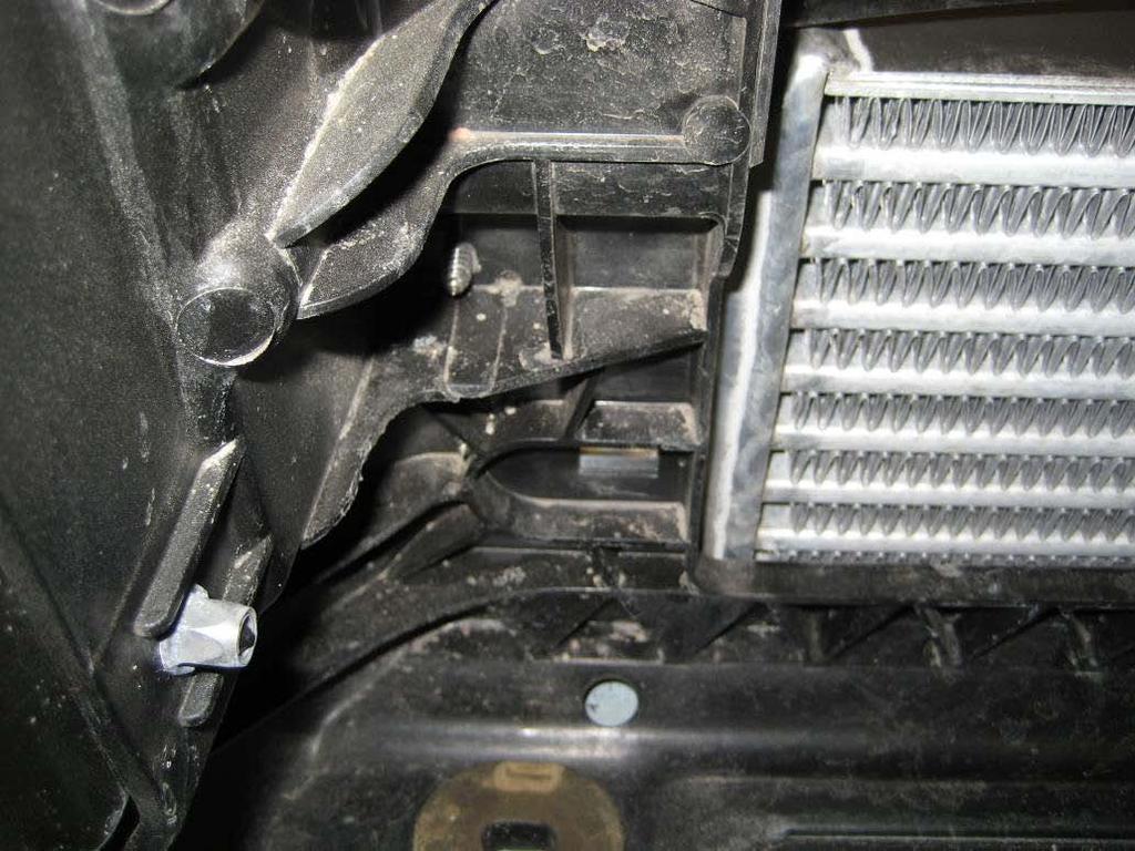 Mark the positions of the two screw holes at each end of the intercooler, then using a small 4mm drill, start a small hole, enough to get the self tapping screws started.