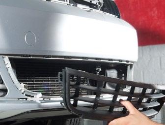 Work your way around the outer edge, releasing the plastic snap retainers until the grille comes out. Repeat this at the opposite side outer grille.