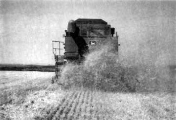 The grain discharged in a compact stream and a full tank of dry wheat was unloaded in about 5 seconds. Unloading rates could be increased by opening the adjustable control gates.