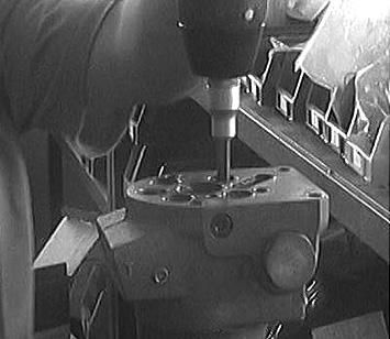 11. Loosen the screws in the valve housing.