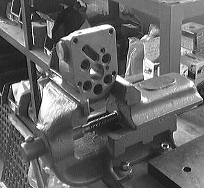 Mount the valve housing in a vise. 3.